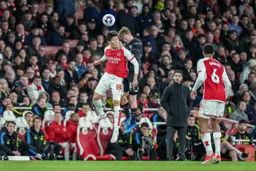 Luke Berry gets up with the Arsenal defender